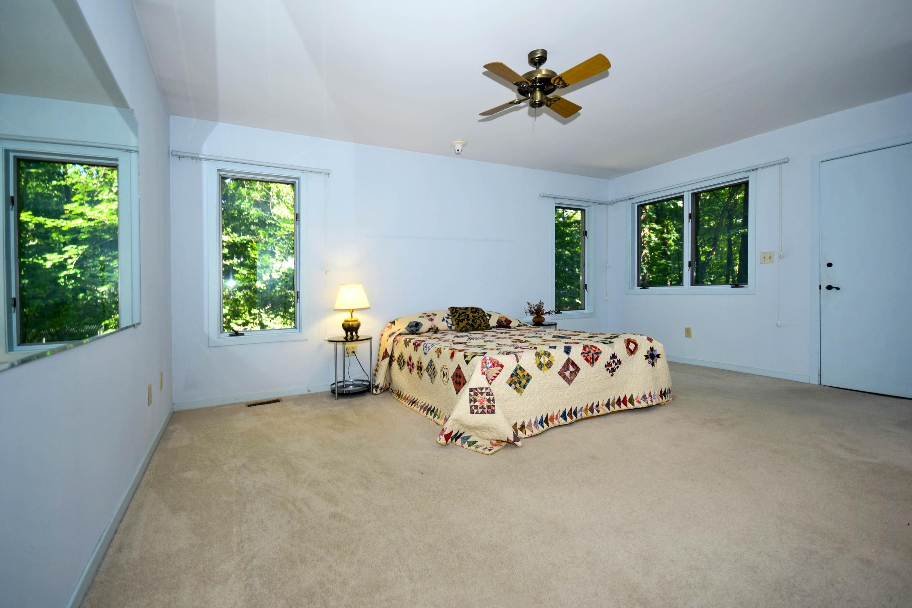 11 Wildcat Road Darien, CT 06820 - Photo 19 of 25 a bed sitting in a bedroom next to a window
