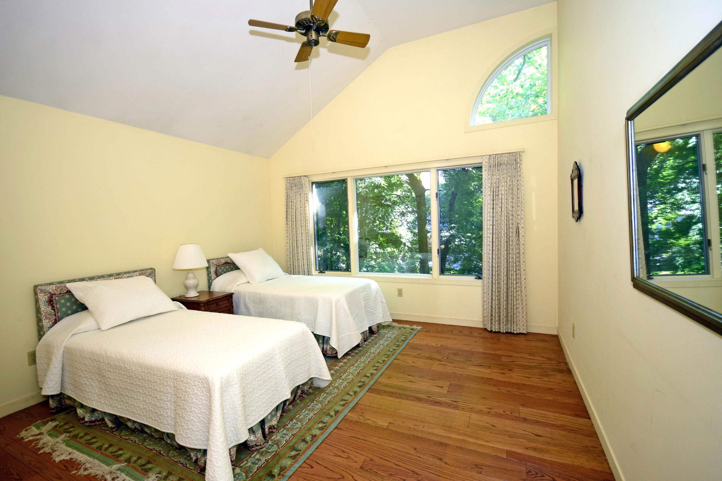 11 Wildcat Road Darien, CT 06820 - Photo 20 of 25 a bedroom with two beds and a large window