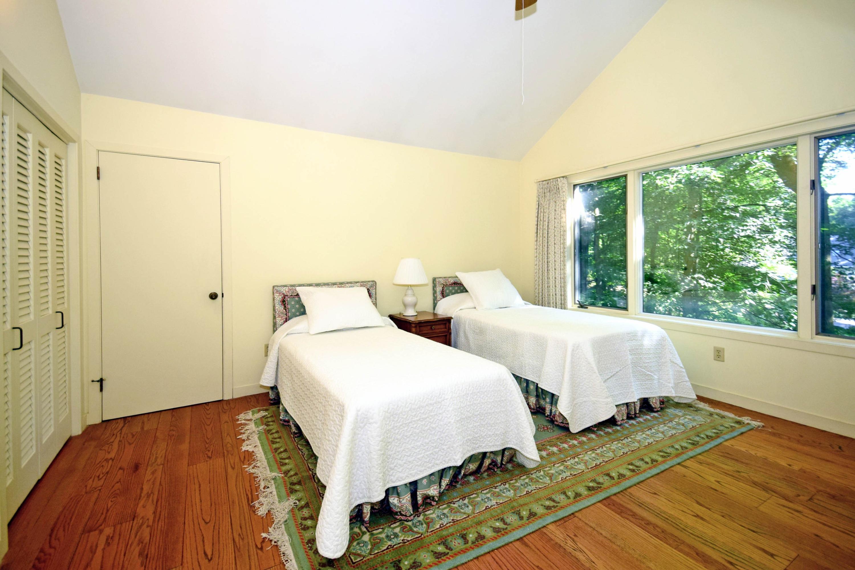11 Wildcat Road Darien, CT 06820 - Photo 21 of 25 a bedroom with two beds and a large window