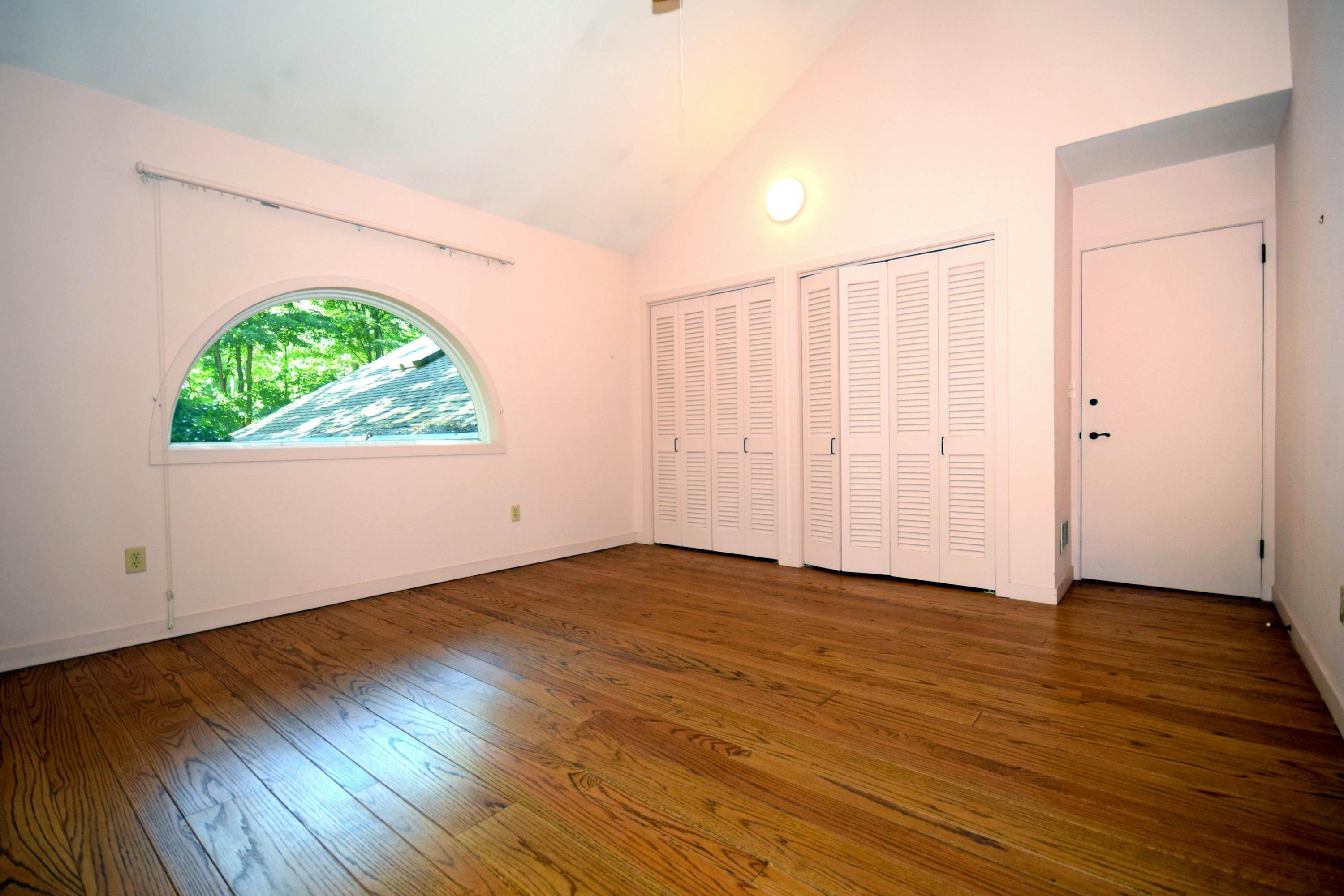 11 Wildcat Road Darien, CT 06820 - Photo 23 of 25 an empty room with wooden floor and windows