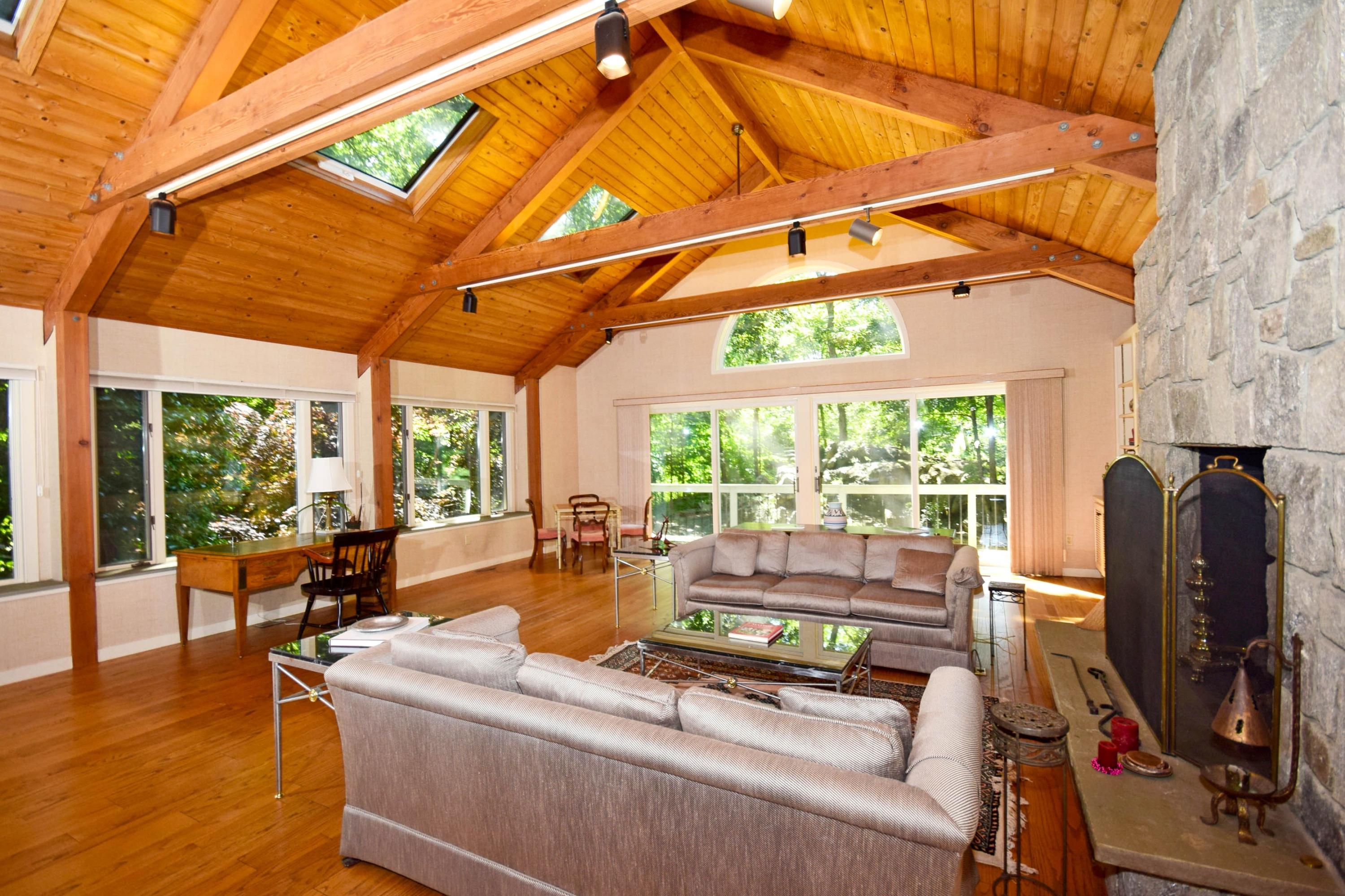 11 Wildcat Road Darien, CT 06820 - Photo 6 of 25 a living room with furniture a flat screen tv and floor to ceiling windows