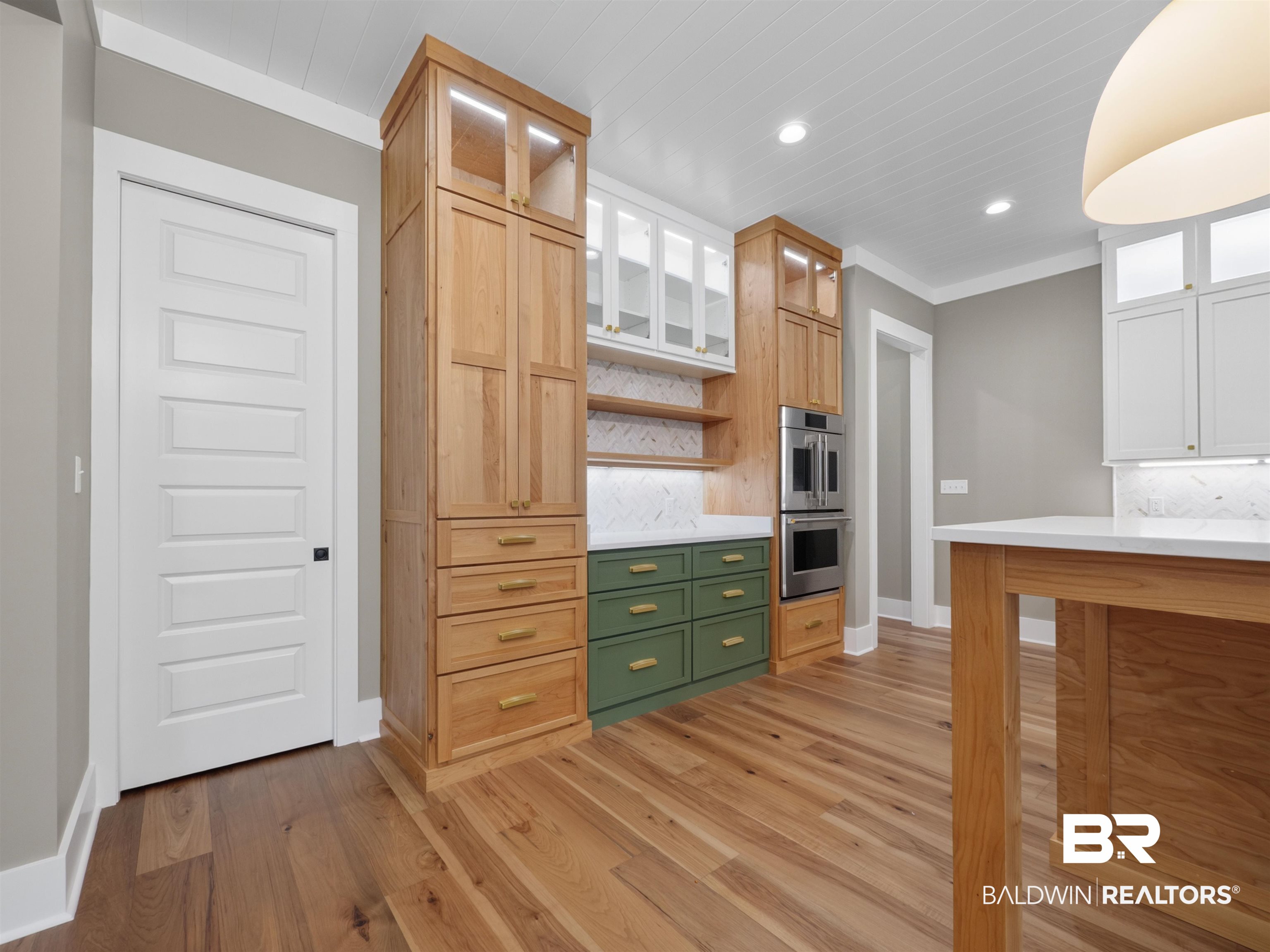 10970 Turin Avenue Fairhope, AL 36532 - Photo 7 of 61 Kitchen with glass insert cabinets, backsplash, open shelves, light wood-style floors, and ornamental molding
