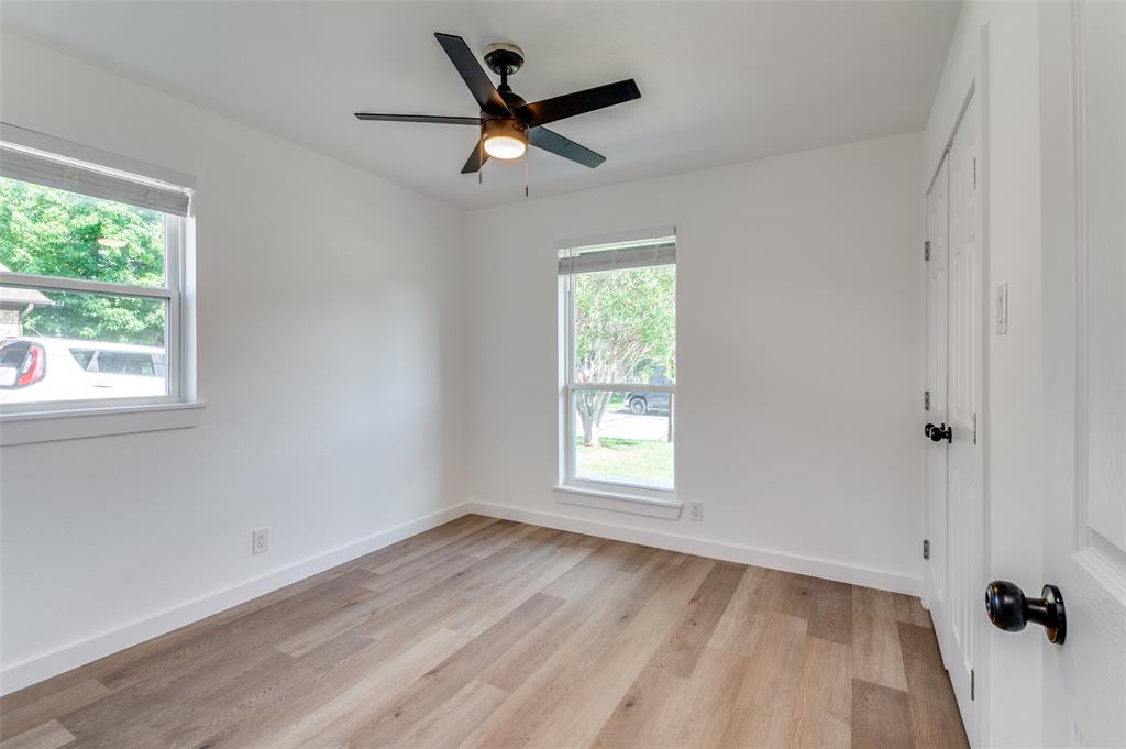 1101 Spring Brook Drive Bedford, TX 76021 - Photo 12 of 17 wooden floor in an empty room with a window