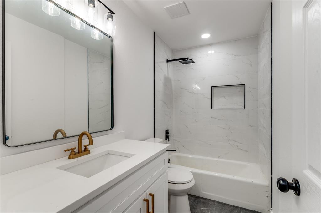 1101 Spring Brook Drive Bedford, TX 76021 - Photo 14 of 17 a bathroom with a sink a toilet and shower