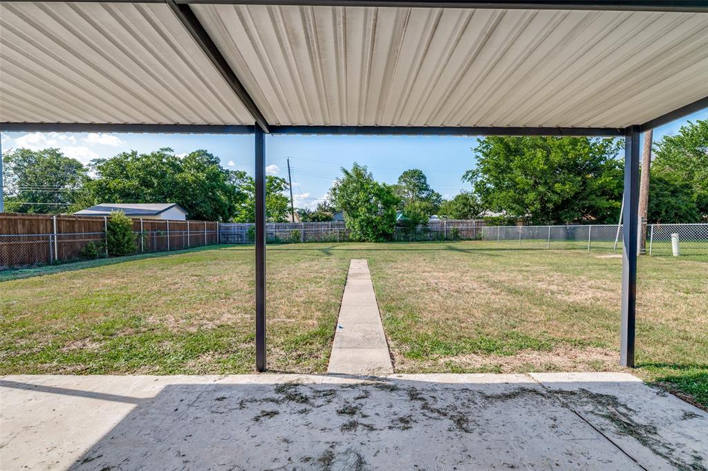 1101 Spring Brook Drive Bedford, TX 76021 - Photo 15 of 17 a view of a house with backyard and a patio