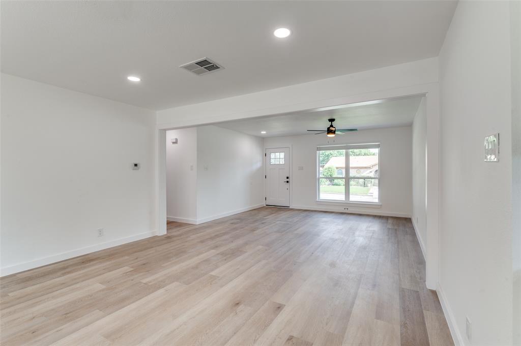 1101 Spring Brook Drive Bedford, TX 76021 - Photo 2 of 17 wooden floor in an empty room with a window
