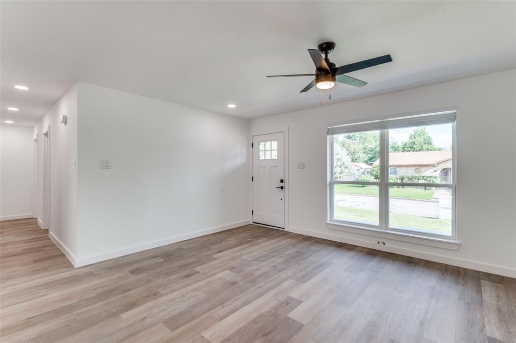1101 Spring Brook Drive Bedford, TX 76021 - Photo 3 of 17 wooden floor in an empty room with a window