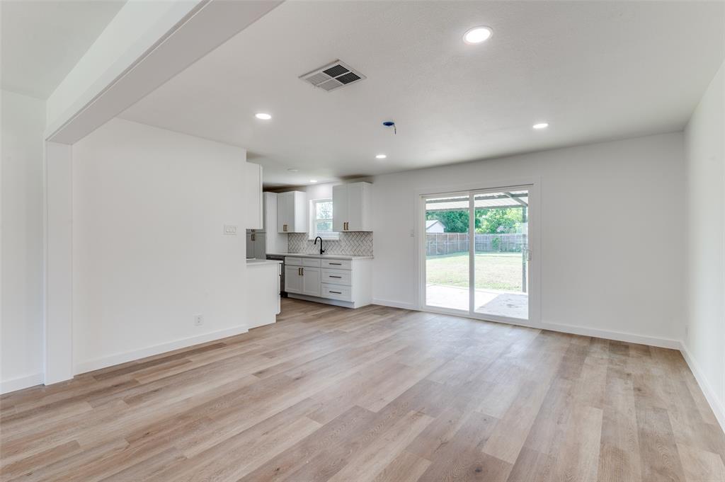 1101 Spring Brook Drive Bedford, TX 76021 - Photo 5 of 17 a view of wooden floor and windows in a room