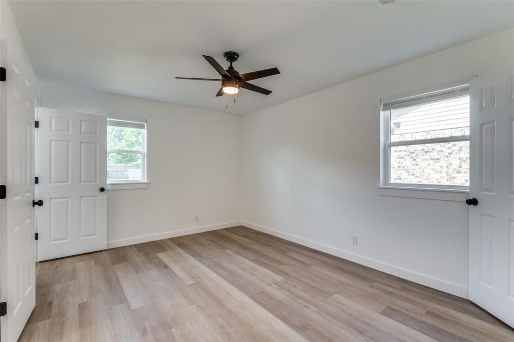 1101 Spring Brook Drive Bedford, TX 76021 - Photo 8 of 17 a view of empty room with wooden floor and fan