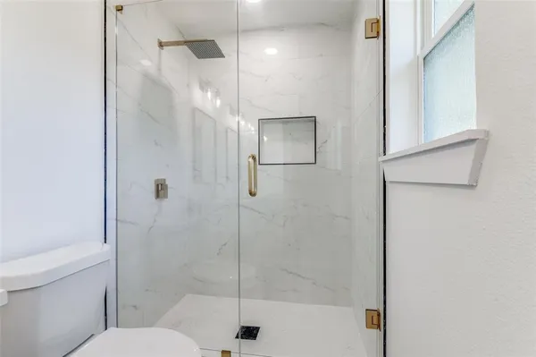 a bathroom with a shower and a toilet
