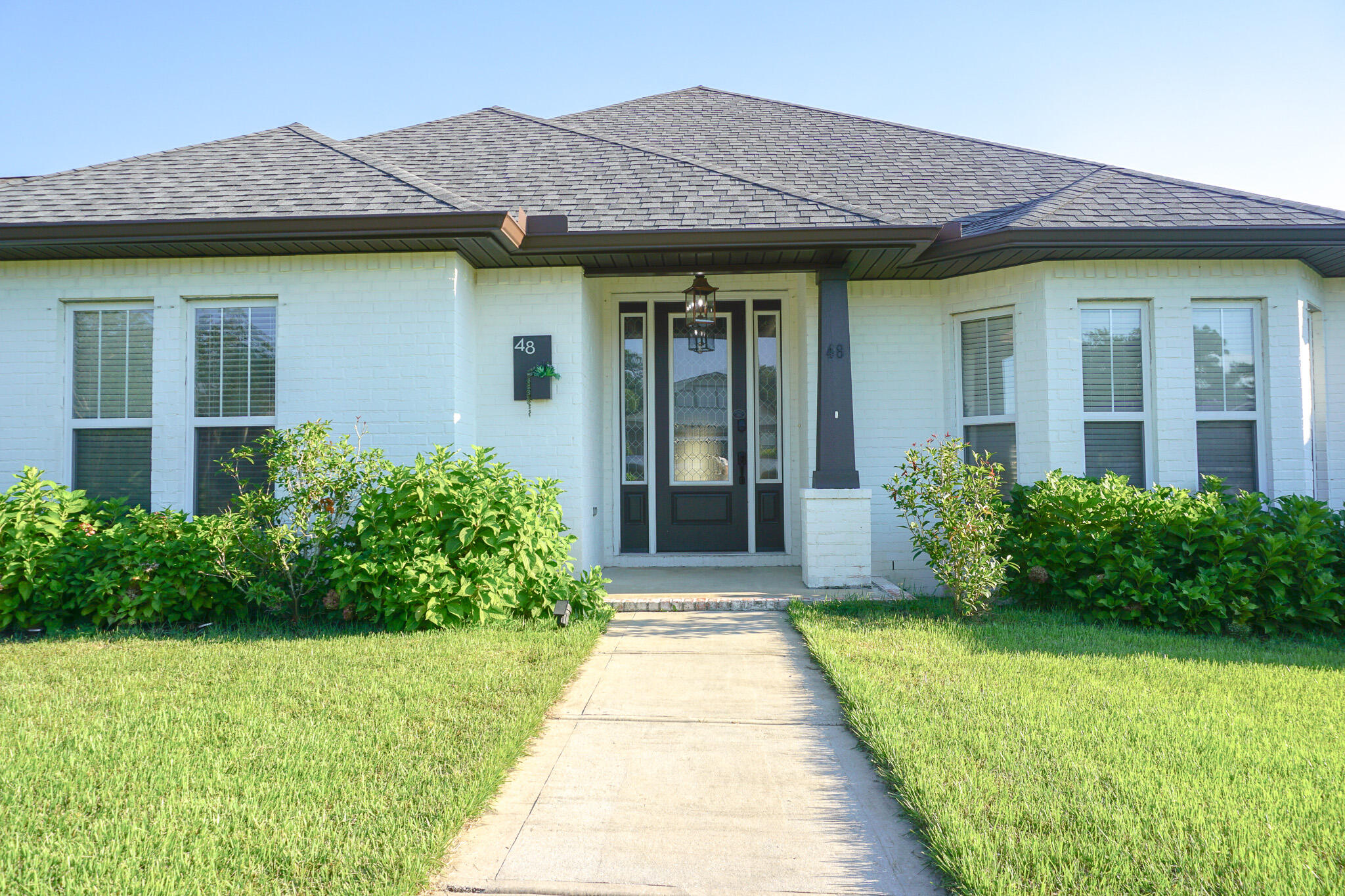 a front view of a house with garden