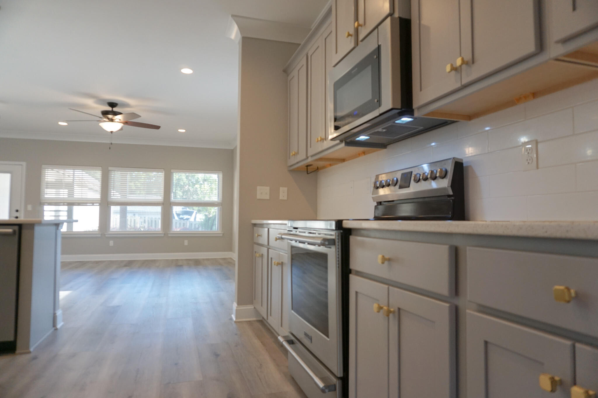 48 9th Avenue Shalimar, FL 32579 - Photo 14 of 60 a kitchen with stainless steel appliances granite countertop a sink a stove and a wooden floors