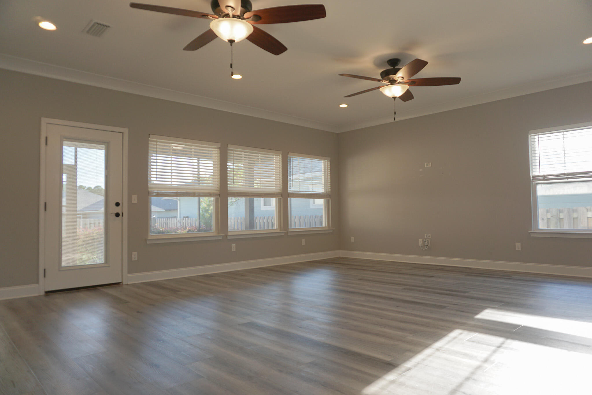 48 9th Avenue Shalimar, FL 32579 - Photo 19 of 60 a view of an empty room with wooden floor and a window