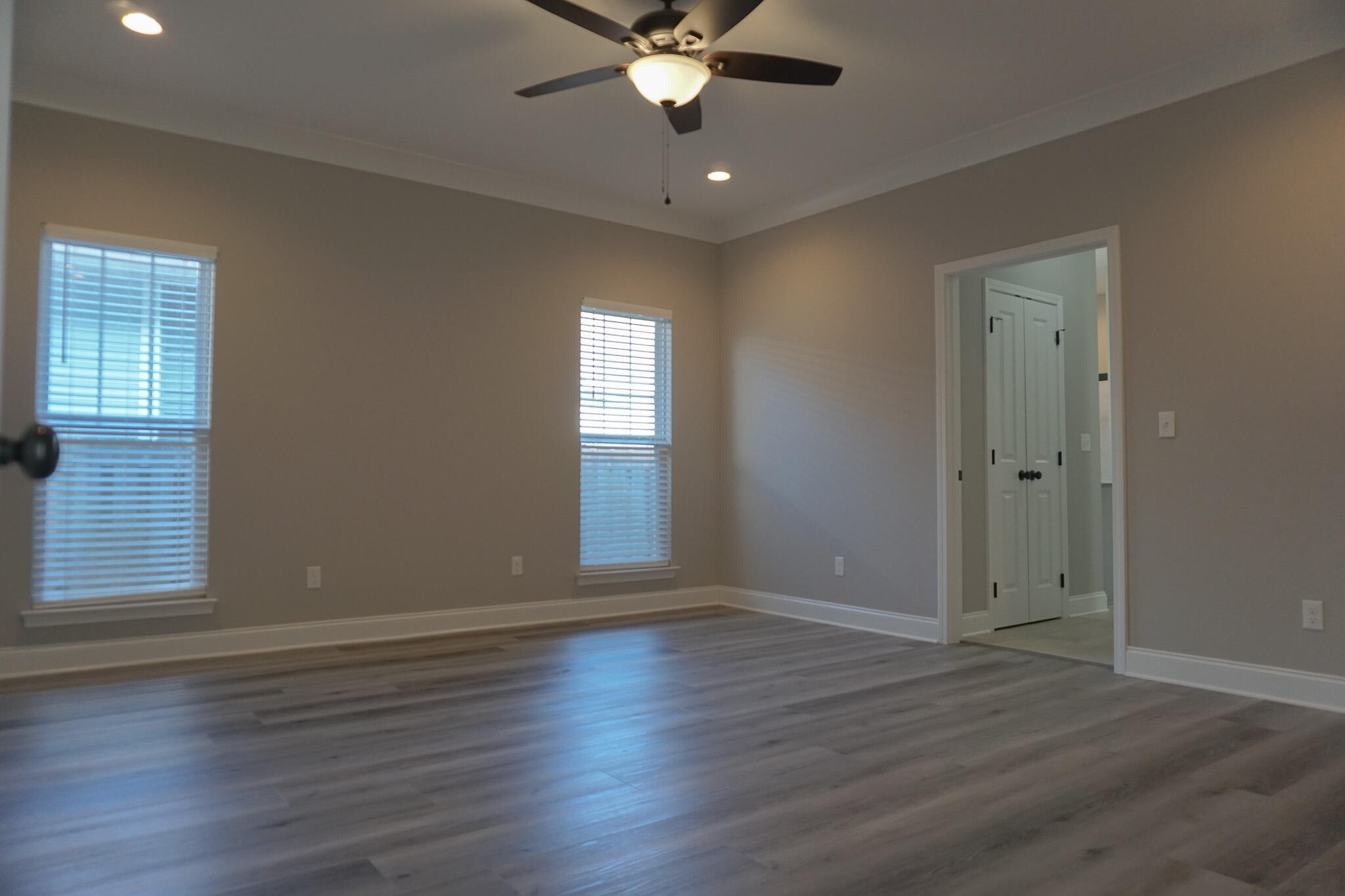 48 9th Avenue Shalimar, FL 32579 - Photo 22 of 60 an empty room with wooden floor fan and windows