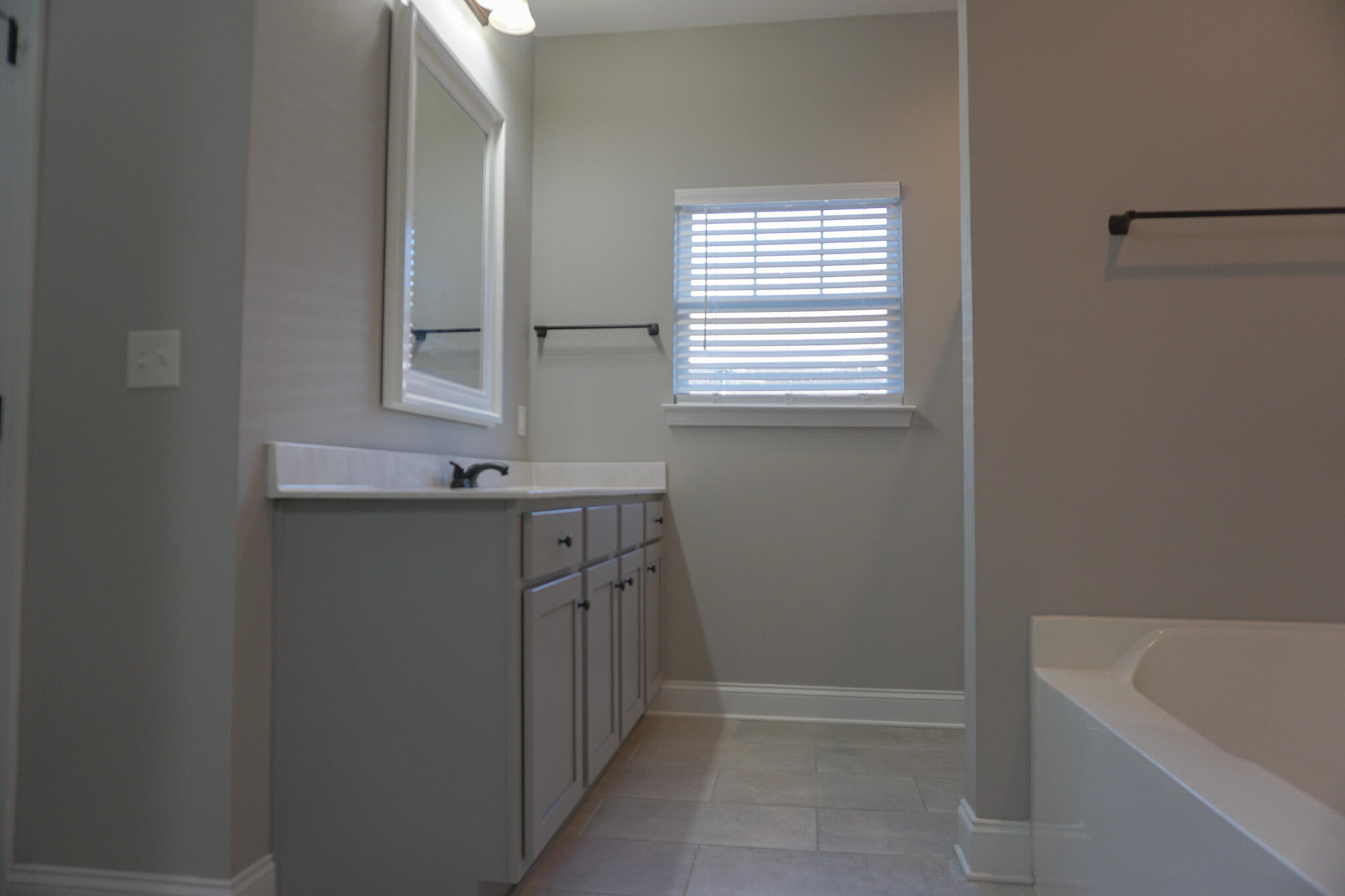 48 9th Avenue Shalimar, FL 32579 - Photo 30 of 60 a bathroom with a tub sink and mirror