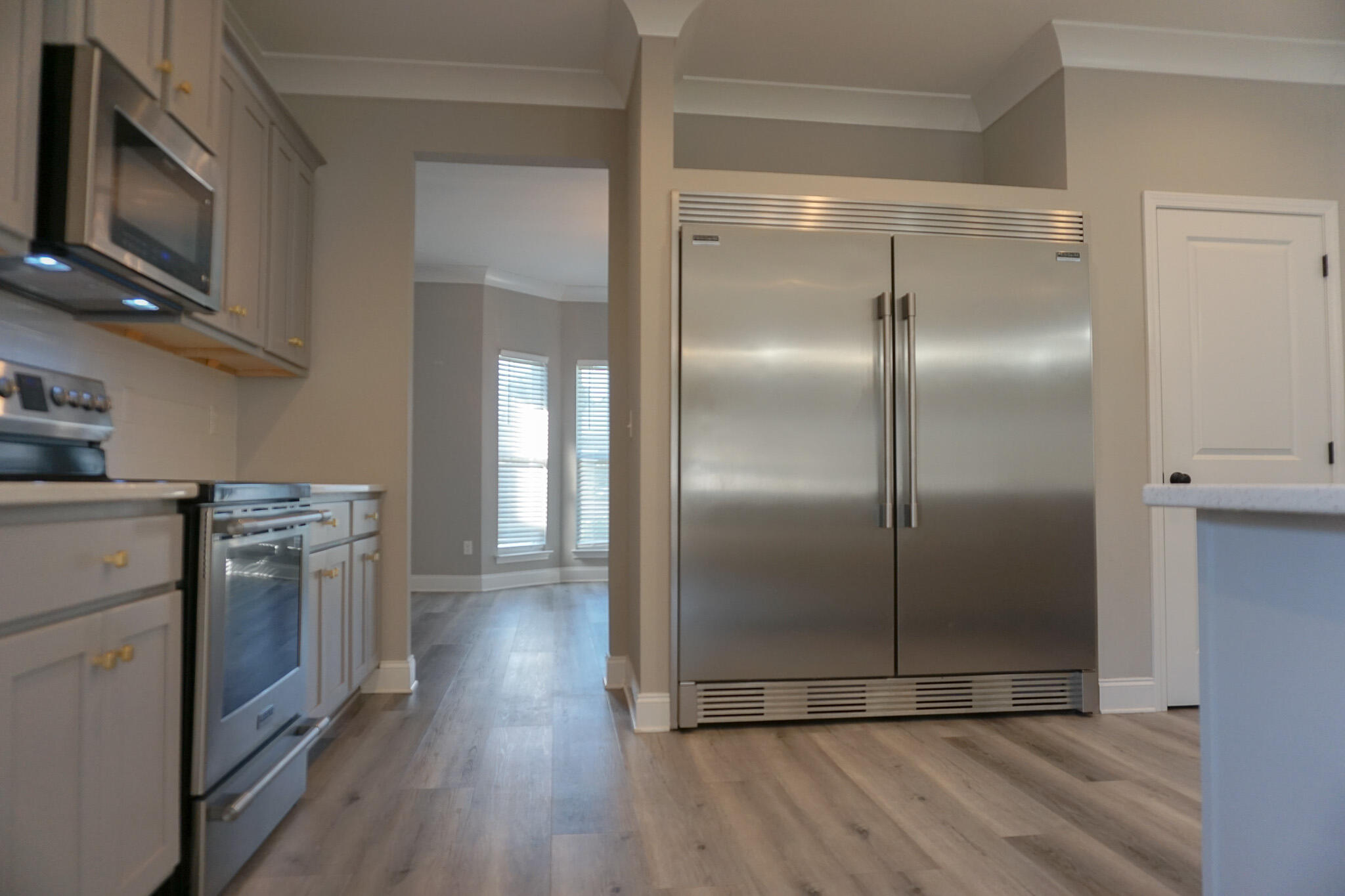 48 9th Avenue Shalimar, FL 32579 - Photo 10 of 60 a kitchen with stainless steel appliances granite countertop a refrigerator a stove top oven and wooden floor