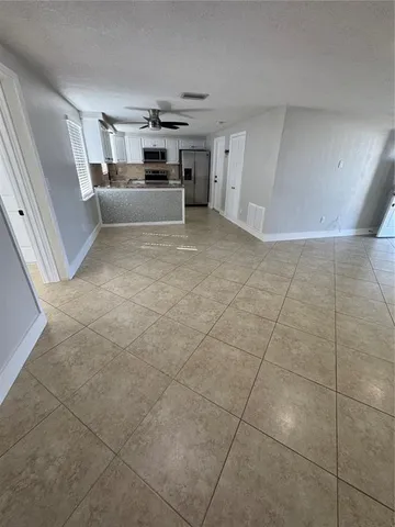 a kitchen with a sink a stove and cabinets