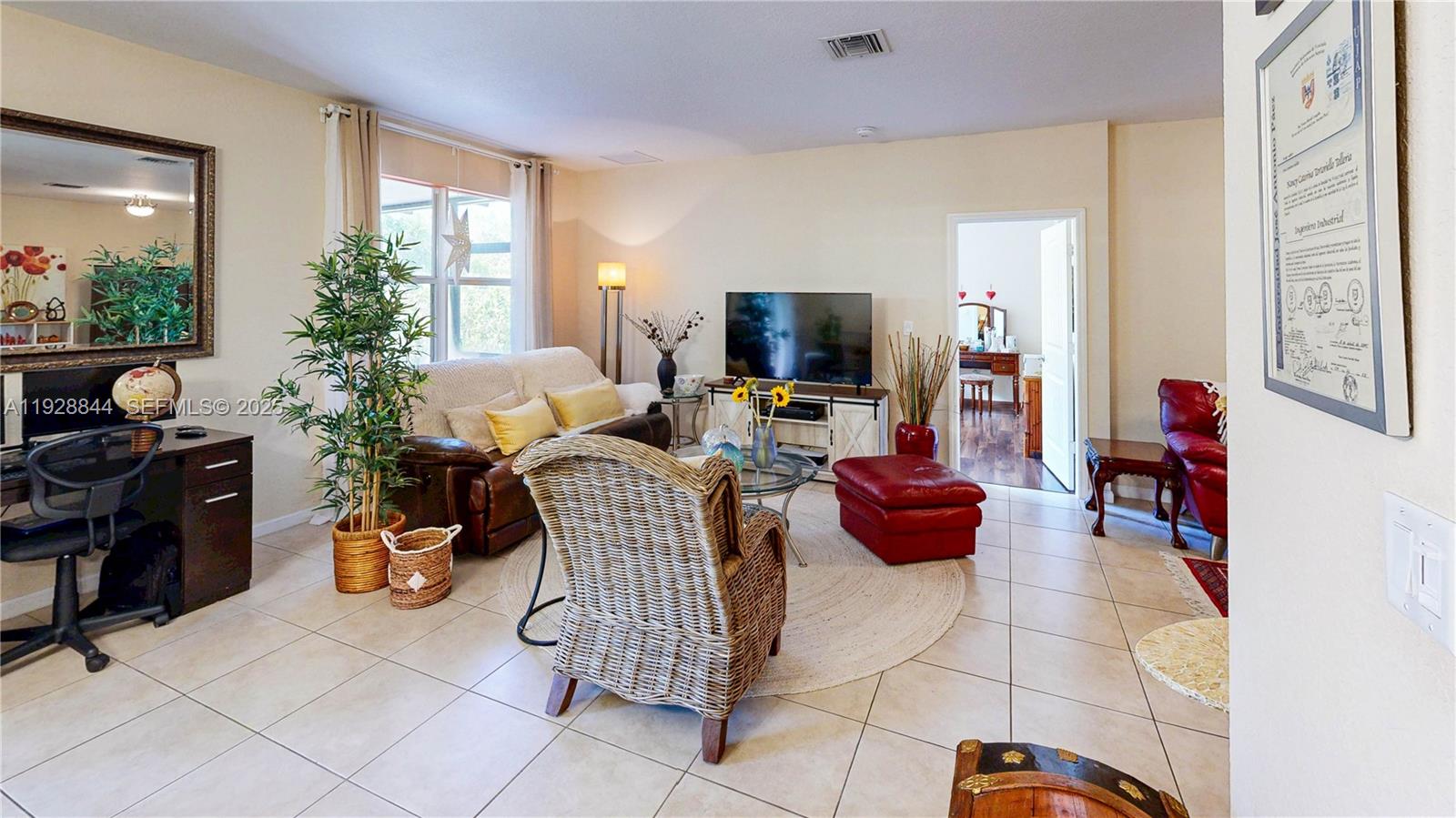 3090 Southeast 7th Court Homestead, FL 33033 - Photo 12 of 80 a living room with furniture and a flat screen tv