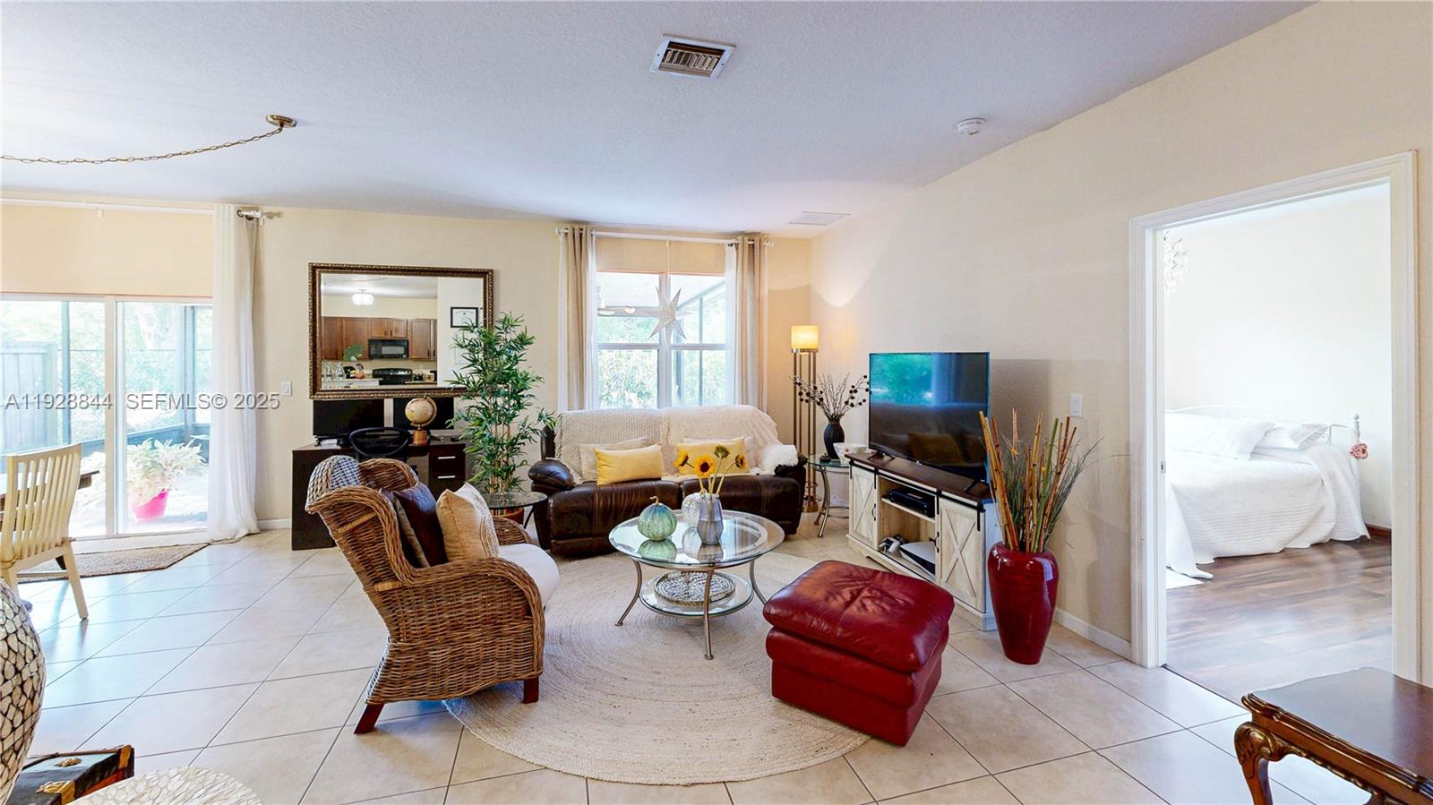3090 Southeast 7th Court Homestead, FL 33033 - Photo 14 of 80 a living room with furniture a flat screen tv and large window