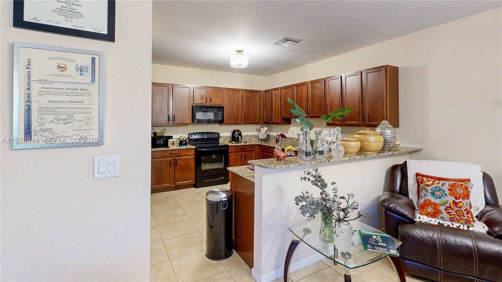 3090 Southeast 7th Court Homestead, FL 33033 - Photo 20 of 80 a kitchen with stainless steel appliances granite countertop a stove a sink a refrigerator a microwave a dining table and chairs with the view