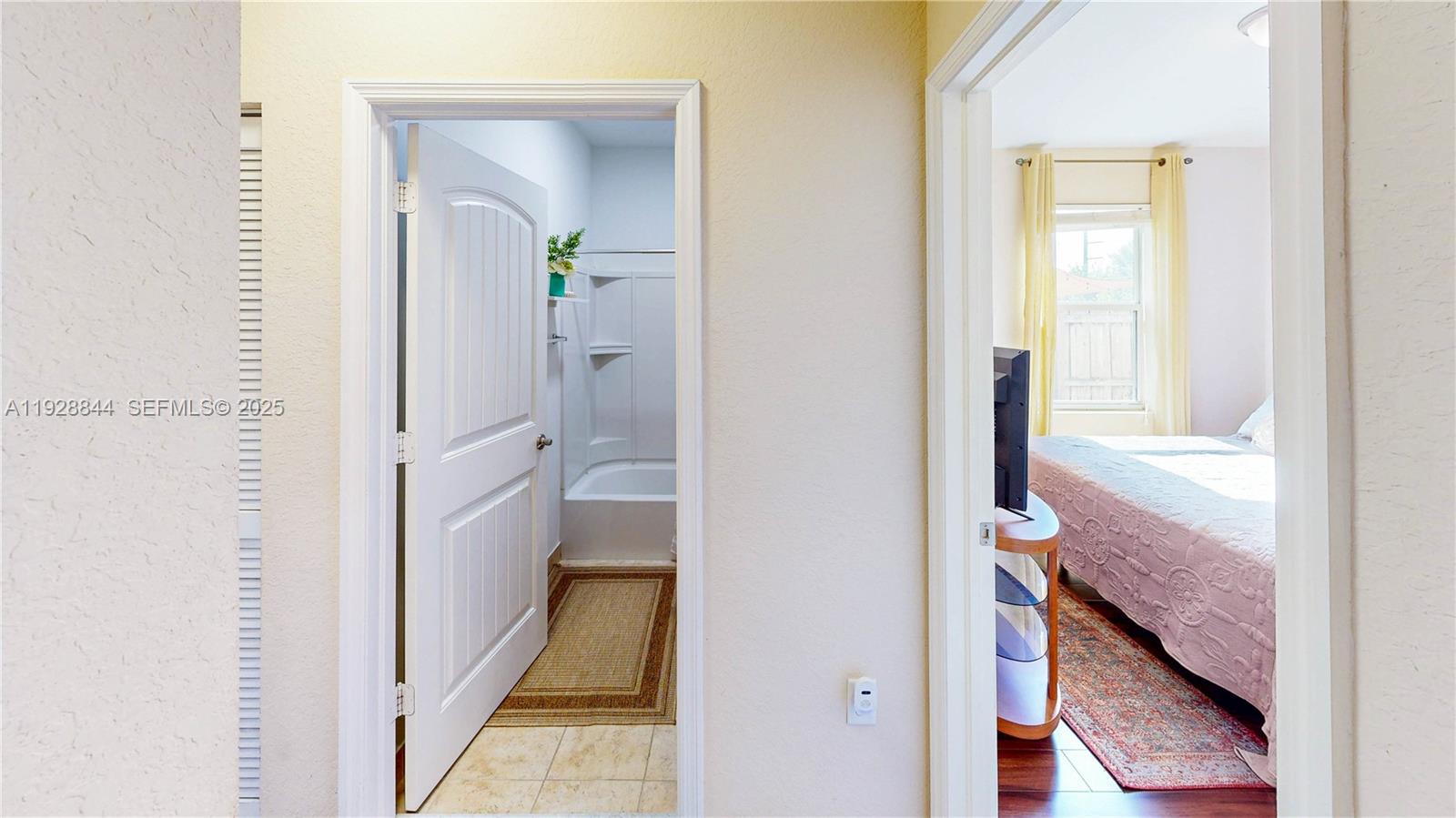 3090 Southeast 7th Court Homestead, FL 33033 - Photo 30 of 80 a view of a hallway with wooden floor and a bathroom