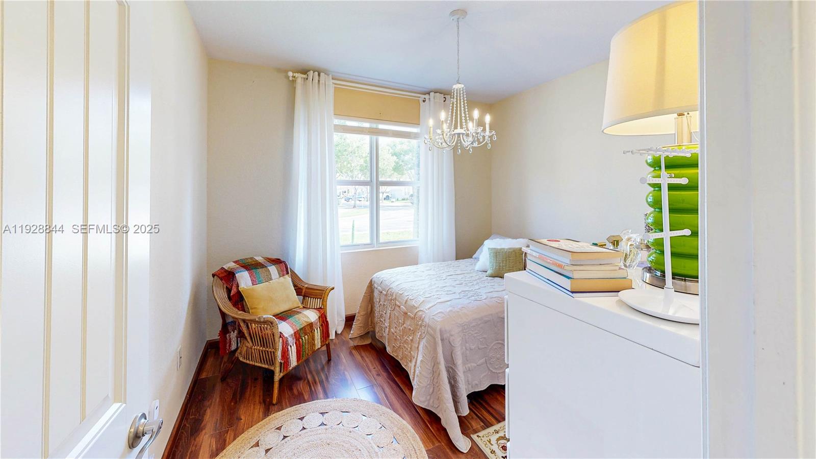 3090 Southeast 7th Court Homestead, FL 33033 - Photo 35 of 80 a bedroom with a bed and a chandelier