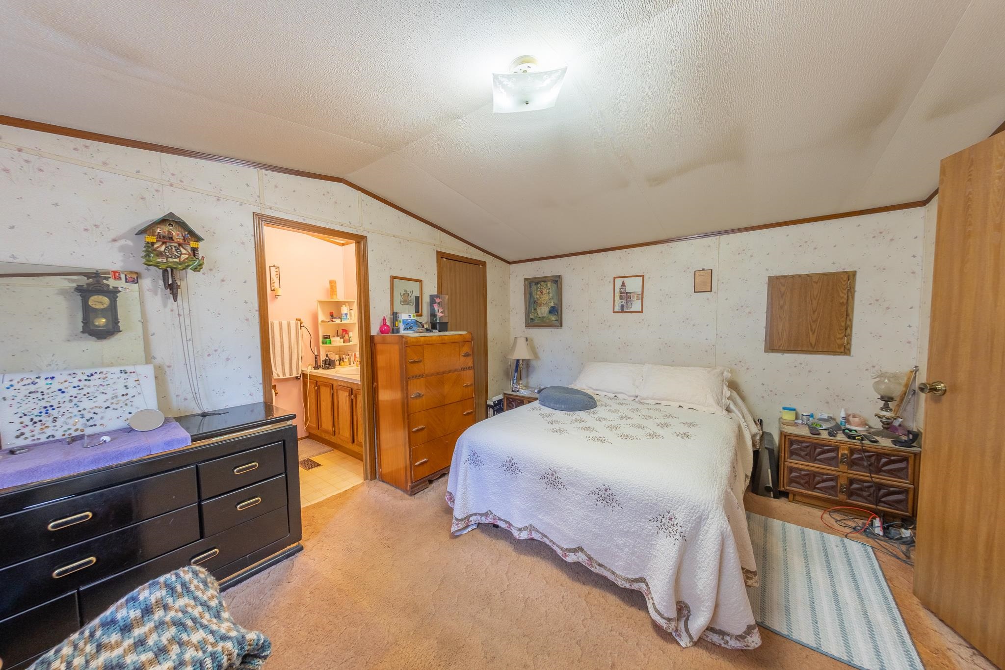 219 Honeysuckle Circle Fruita, CO 81521 - Photo 13 of 16 a bedroom with a bed and wooden floor