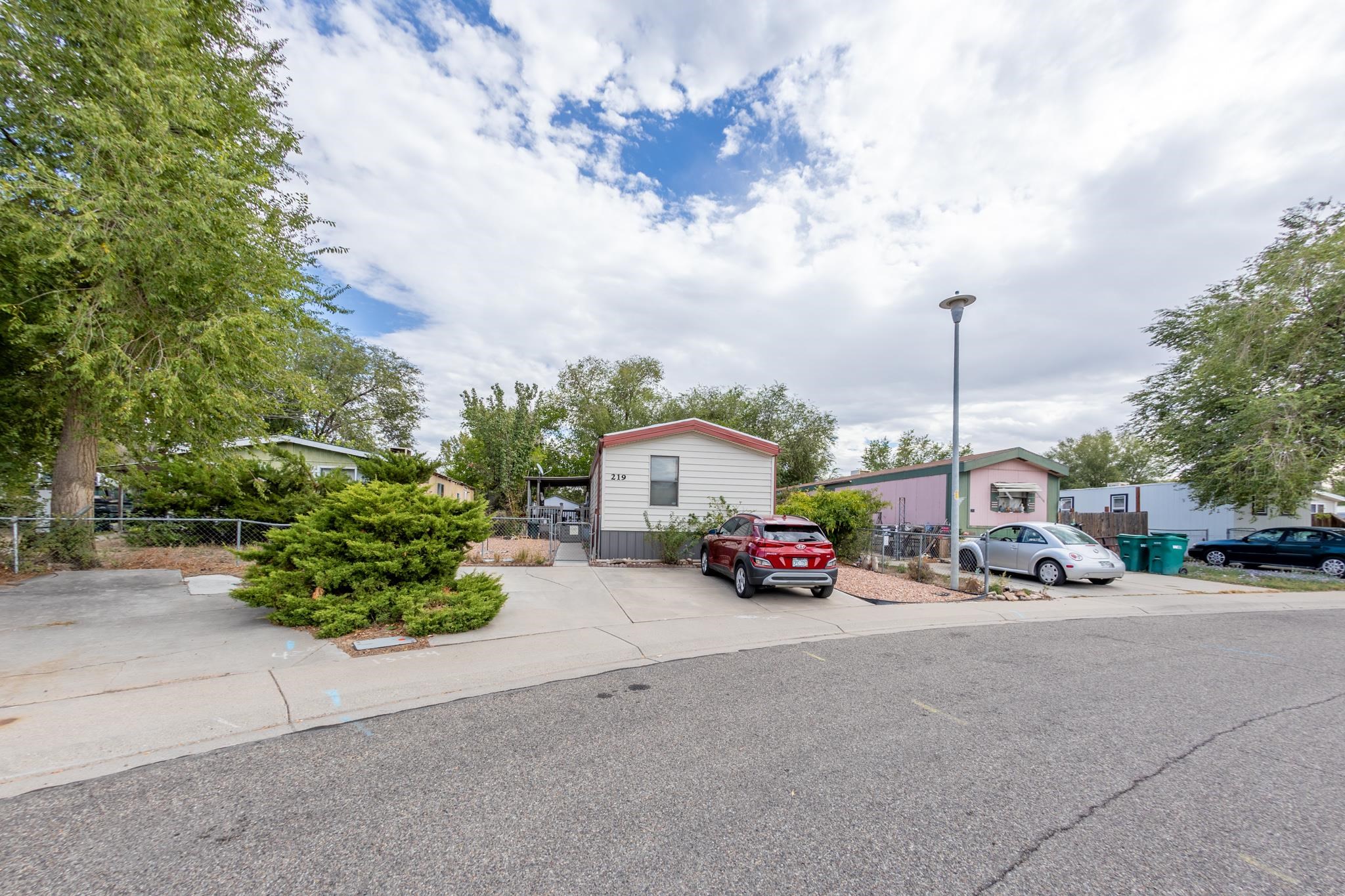 219 Honeysuckle Circle Fruita, CO 81521 - Photo 2 of 16 a car parked on the side of the road