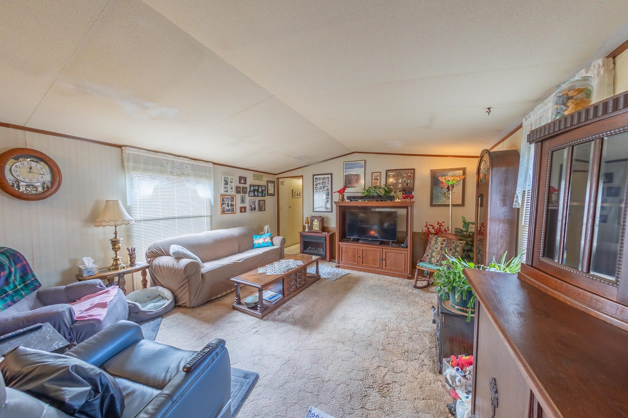 219 Honeysuckle Circle Fruita, CO 81521 - Photo 4 of 16 a living room with furniture and a flat screen tv