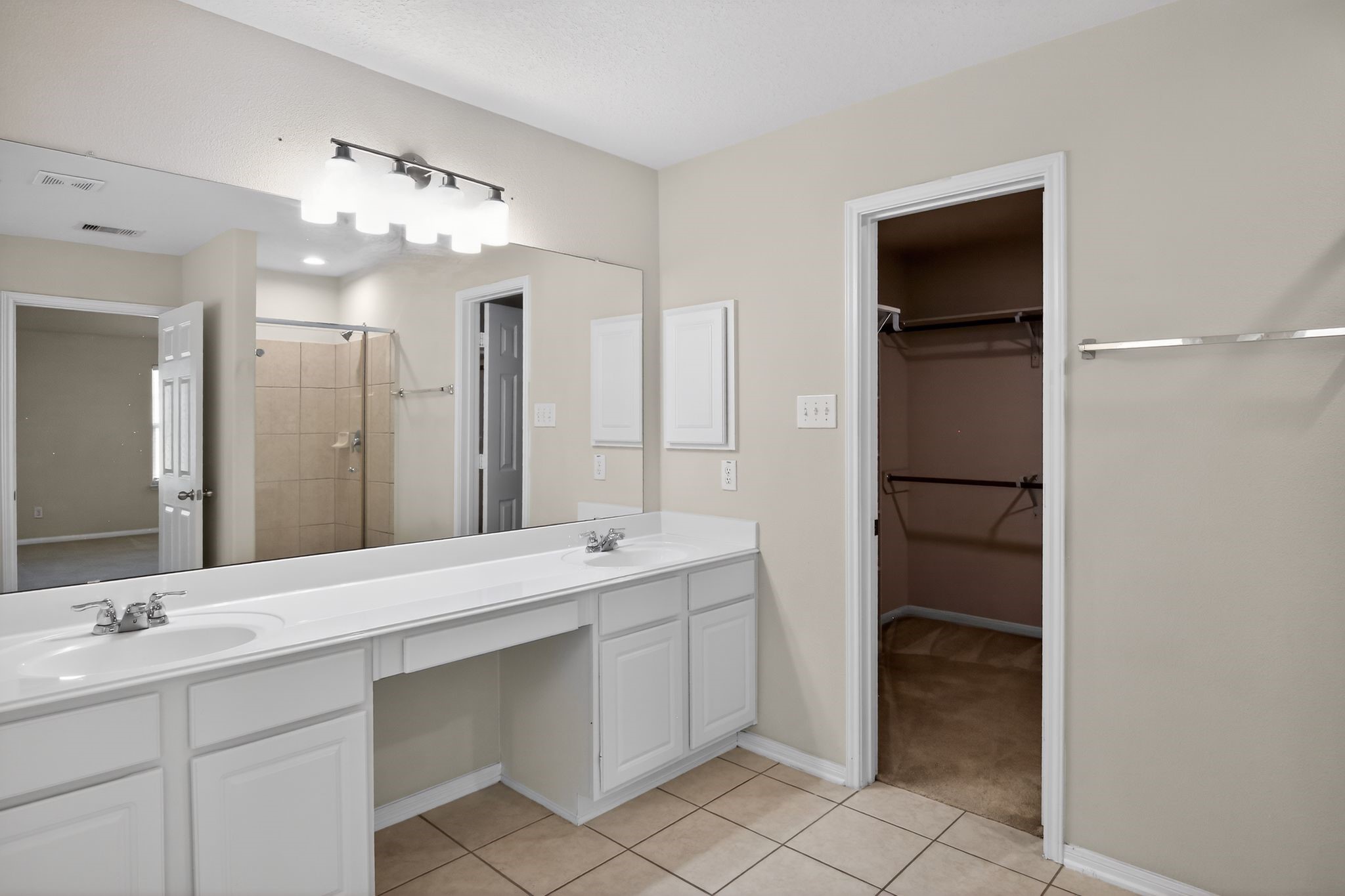 4938 Yearling Ridge Court Katy, TX 77449 - Photo 14 of 29 a bathroom with a double vanity sink and a mirror