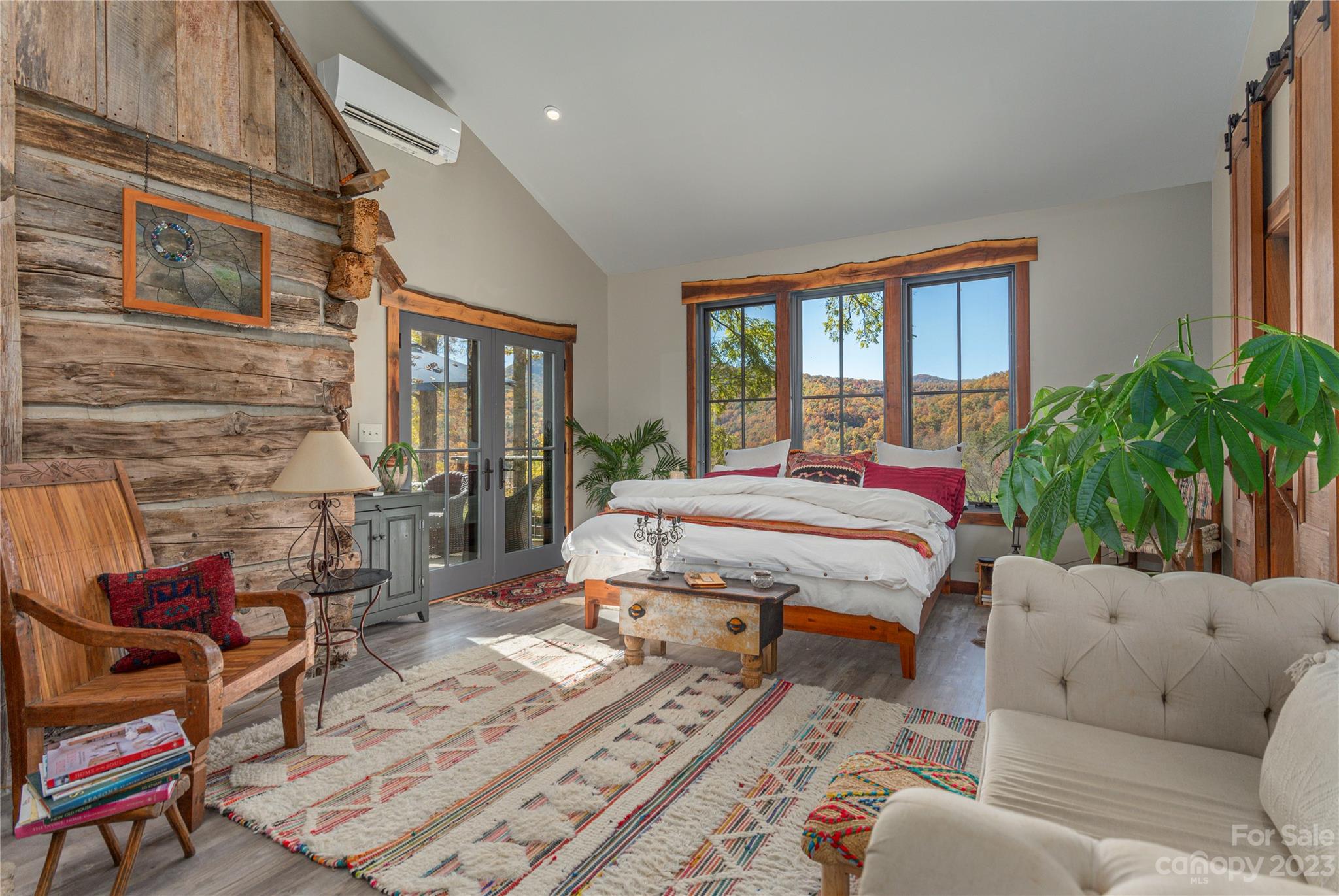 33 Taproot Trail Barnardsville, NC 28709 - Photo 14 of 46 a spacious bedroom with a bed a couch and a potted plant