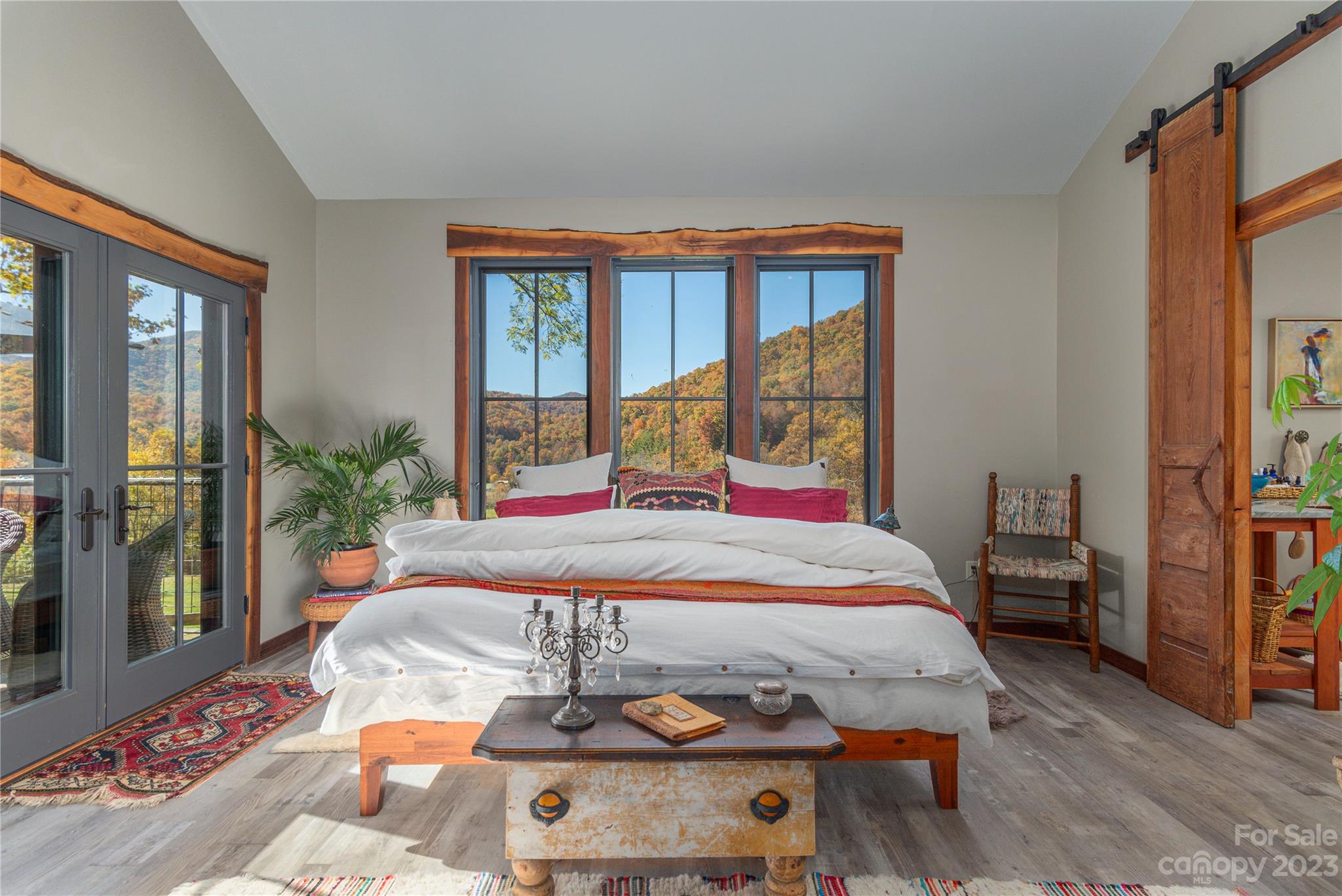 33 Taproot Trail Barnardsville, NC 28709 - Photo 15 of 46 a bedroom with a bed and large windows