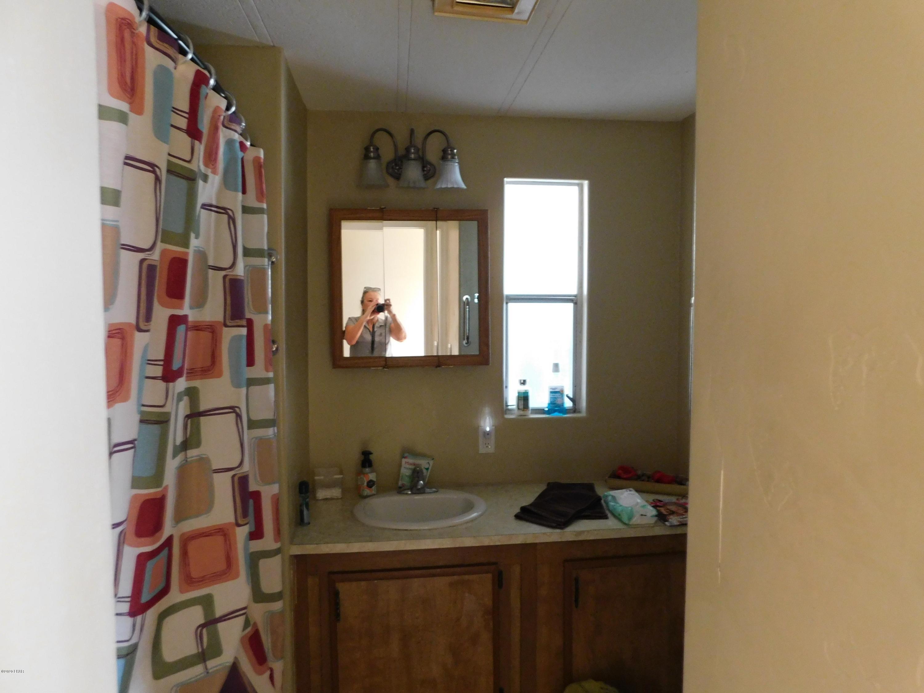 10176 Harbor View Road Parker, AZ 85344 - Photo 11 of 14 a bathroom with a granite countertop sink and a mirror