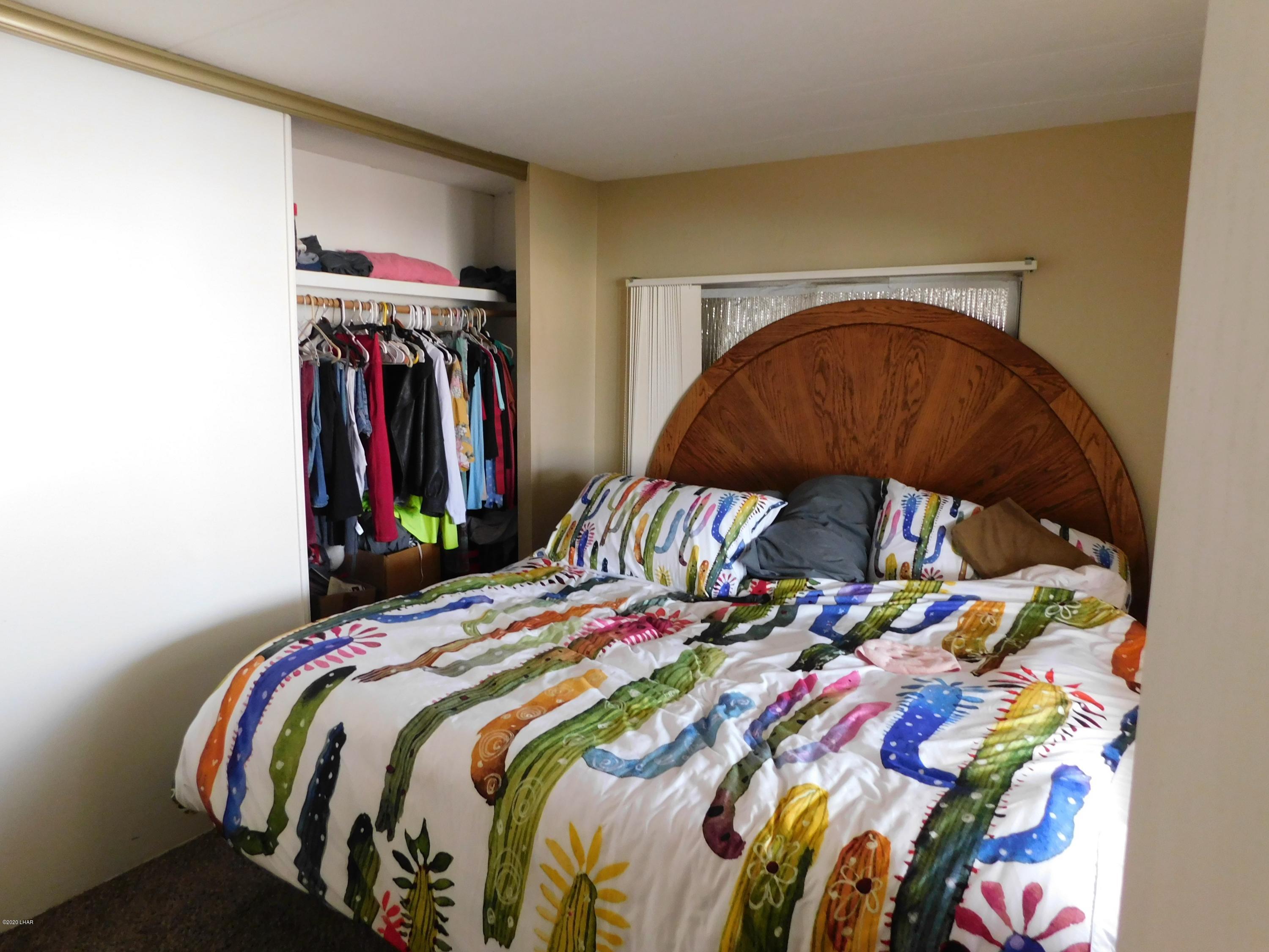 10176 Harbor View Road Parker, AZ 85344 - Photo 8 of 14 a bedroom with a bed and a painting on the wall