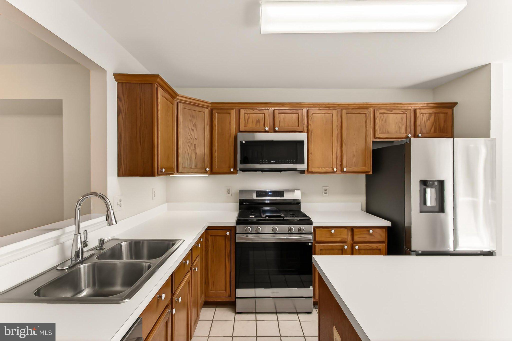 13157 Kidwell Field Road Herndon, VA 20171 - Photo 16 of 50 Modern kitchen with warm wood tones.