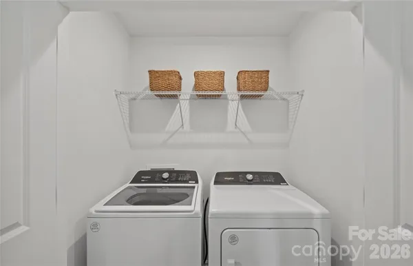 a view of storage and utility room with washer and dryer
