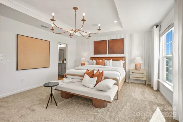 a bedroom with furniture and a large window