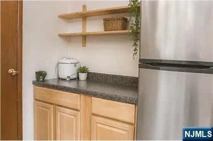 a kitchen with a refrigerator and cabinets