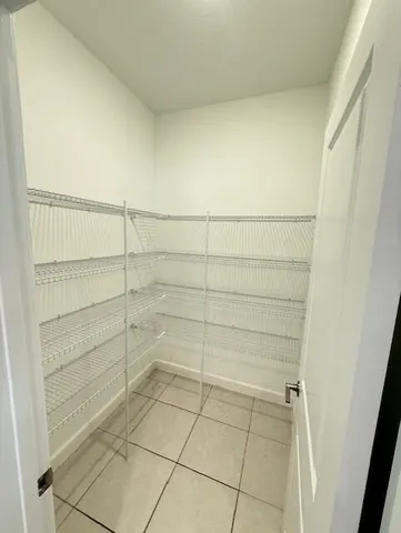 a kitchen with stainless steel appliances a refrigerator sink and microwave