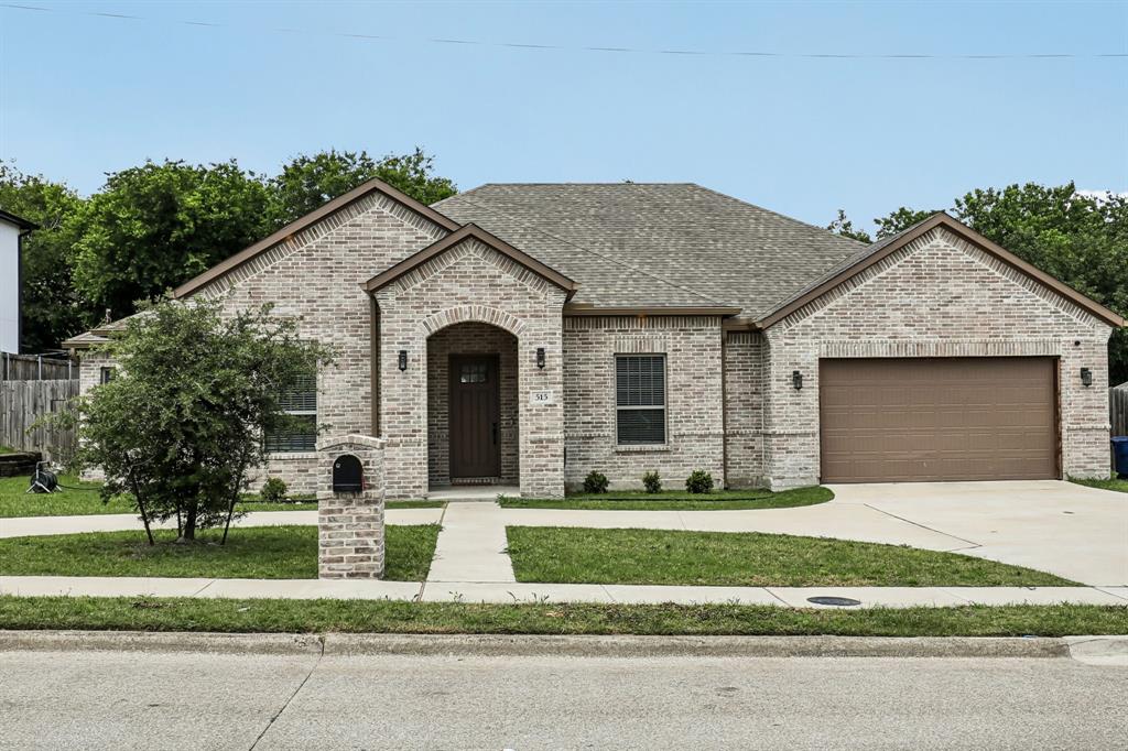 515 West Laureland Road Dallas, TX 75232 - Photo 2 of 32 a front view of a house with a yard and garage