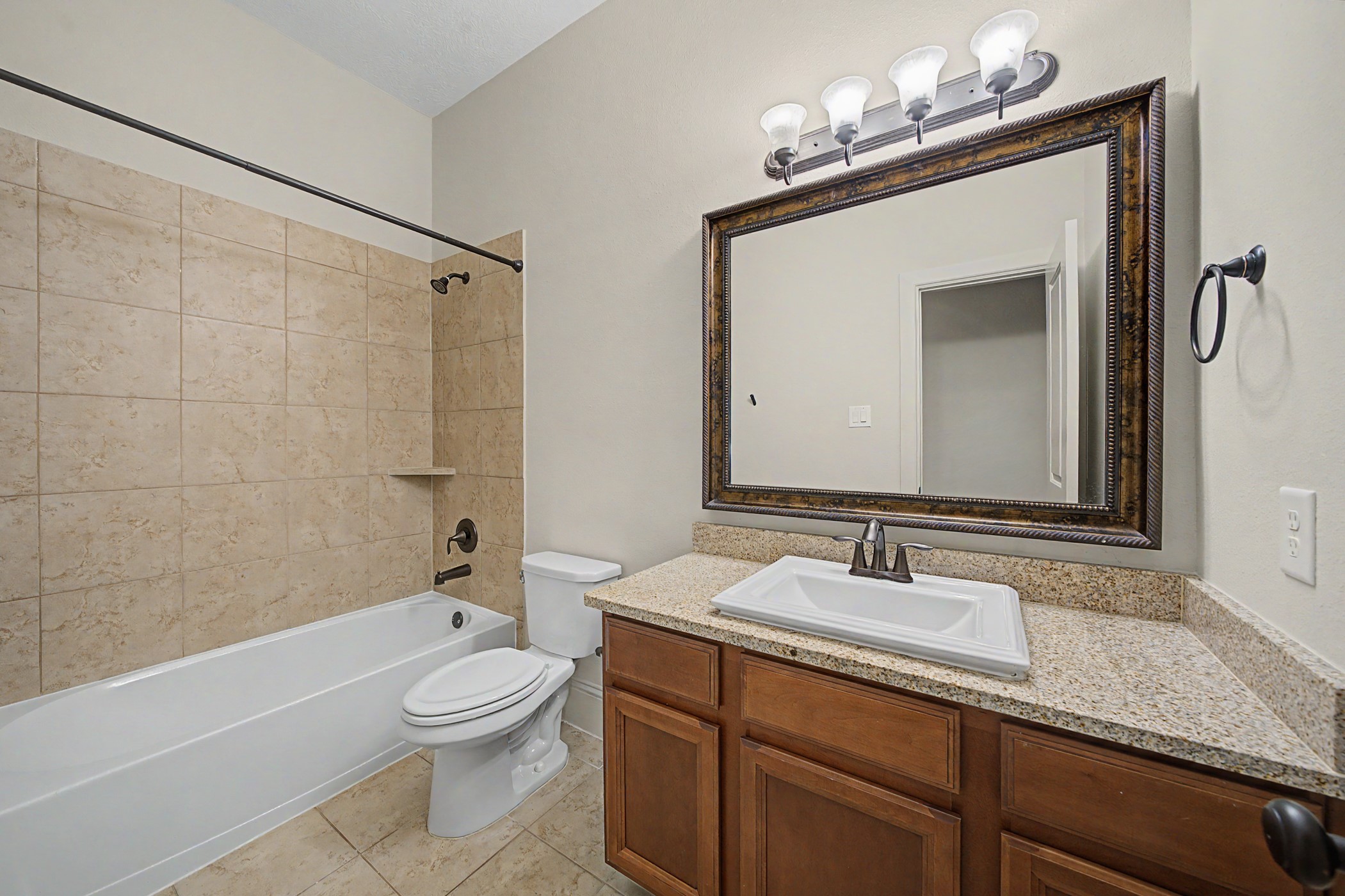 31032 Sunfall Trail Lane Spring, TX 77386 - Photo 22 of 39 a bathroom with a granite countertop sink a toilet mirror and bathtub