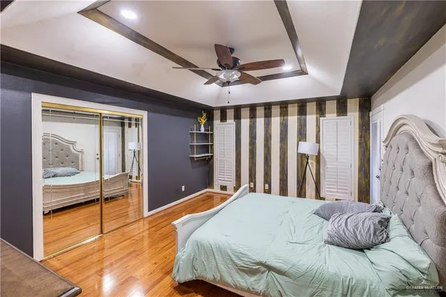 a bedroom with a large bed and a chandelier