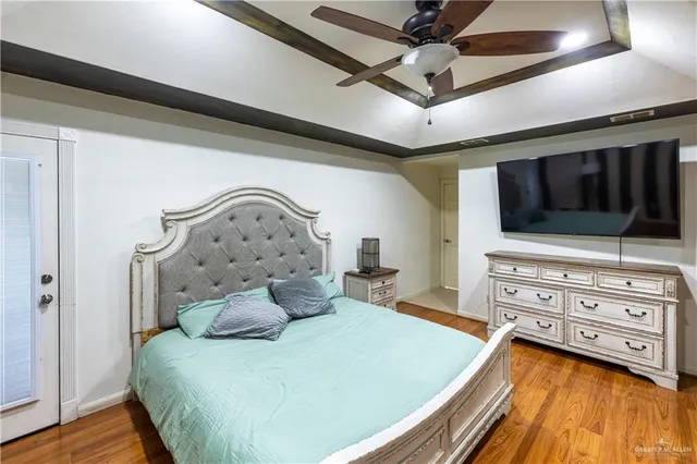 a bedroom with a bed and wooden floor