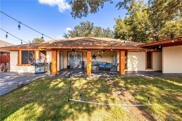 a view of a house with floor to ceiling windows and a basket ball poll