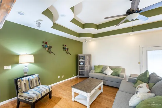 a living room with furniture and painting on the wall