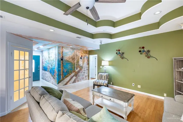 a living room with a bed furniture and a large window