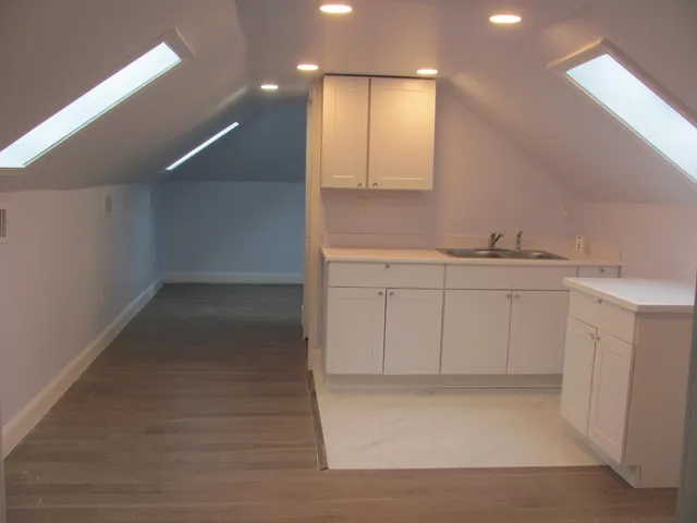 a view of cabinets a sink and dishwasher in a room