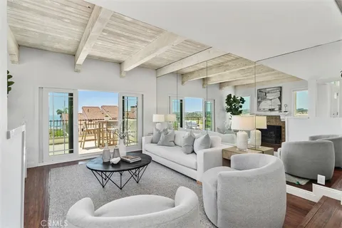 a living room with fireplace furniture and a wooden floor