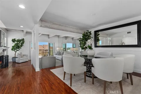 a living room with furniture and a view of kitchen