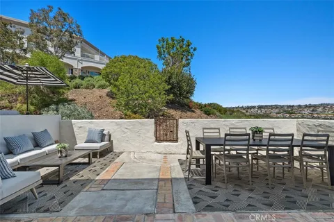 an aerial view of a house with a swimming pool patio and outdoor seating